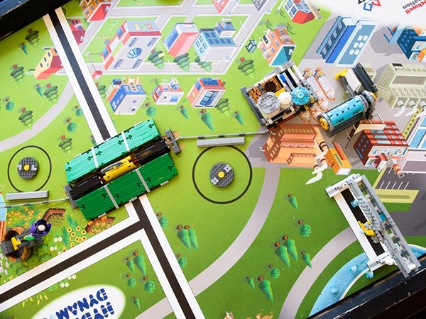 Tabletop model of a Lego cityscape with buildings, roads, and several Lego structures.